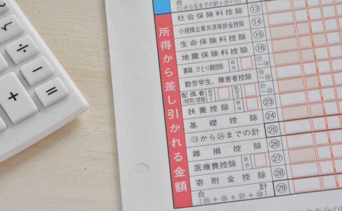 所得税の申告用紙と電卓、所得控除に関連するイメージ